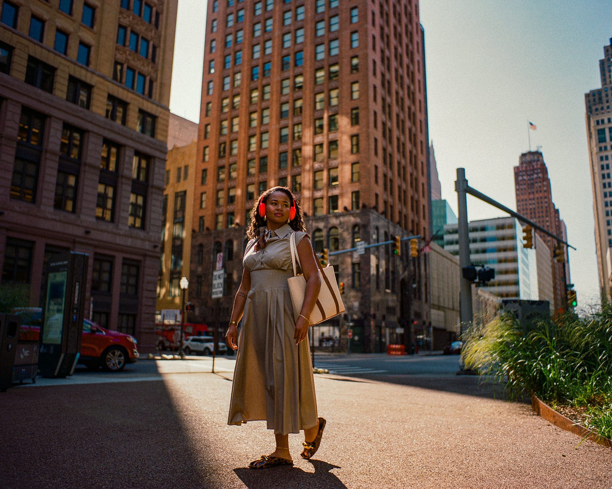 Woman walking past downtown towers