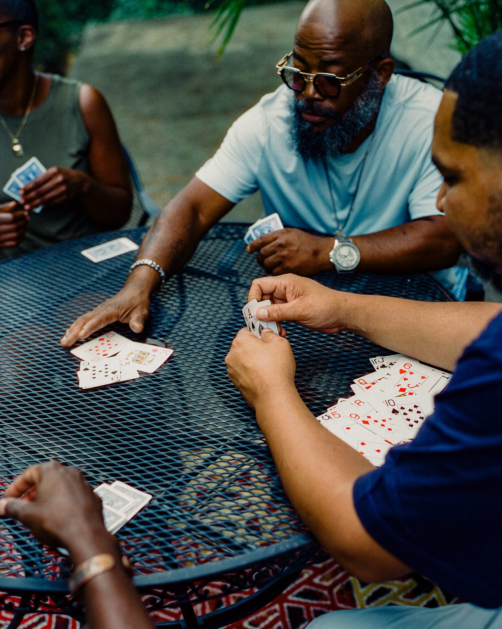 Friends playing cards at a patio table